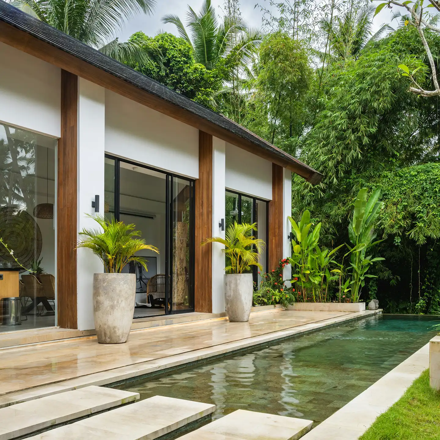 Modern house exterior with landscaped garden and paved driveway