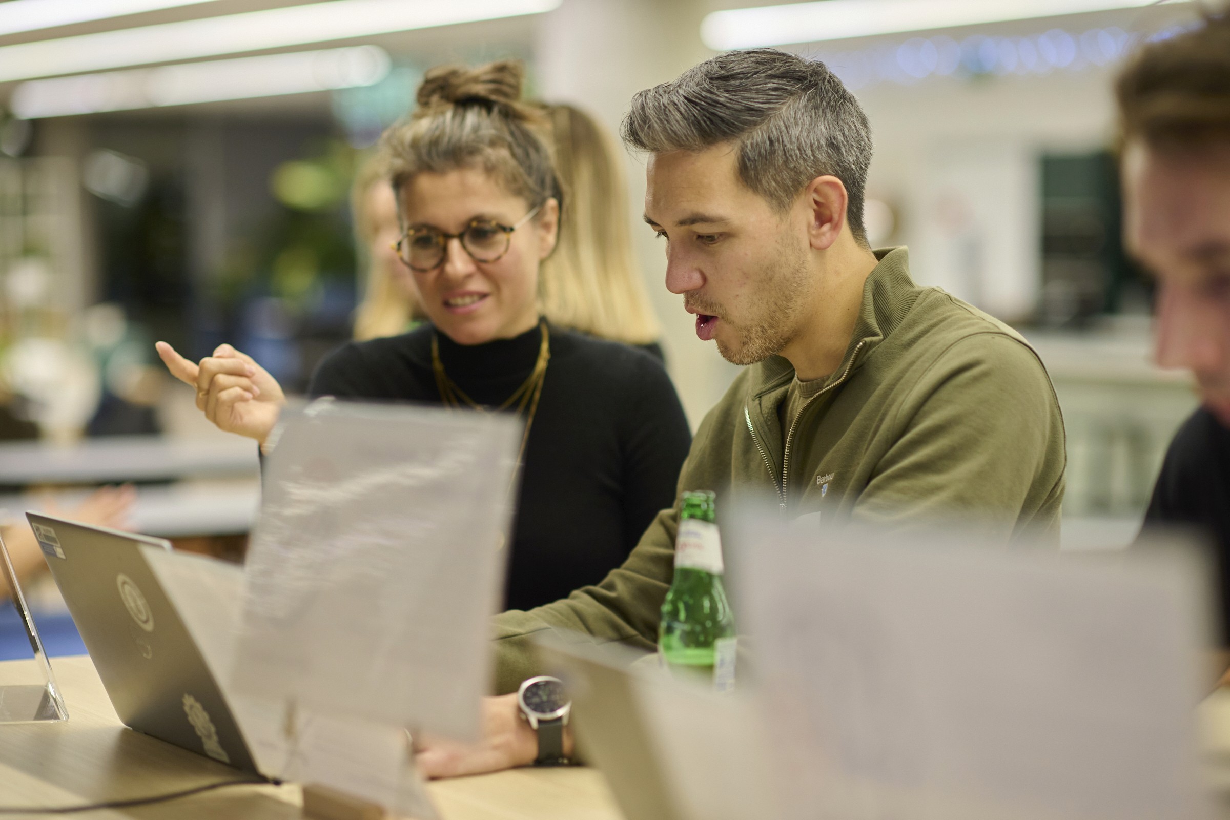 Deni explaining how to design for Autism in front of a laptop