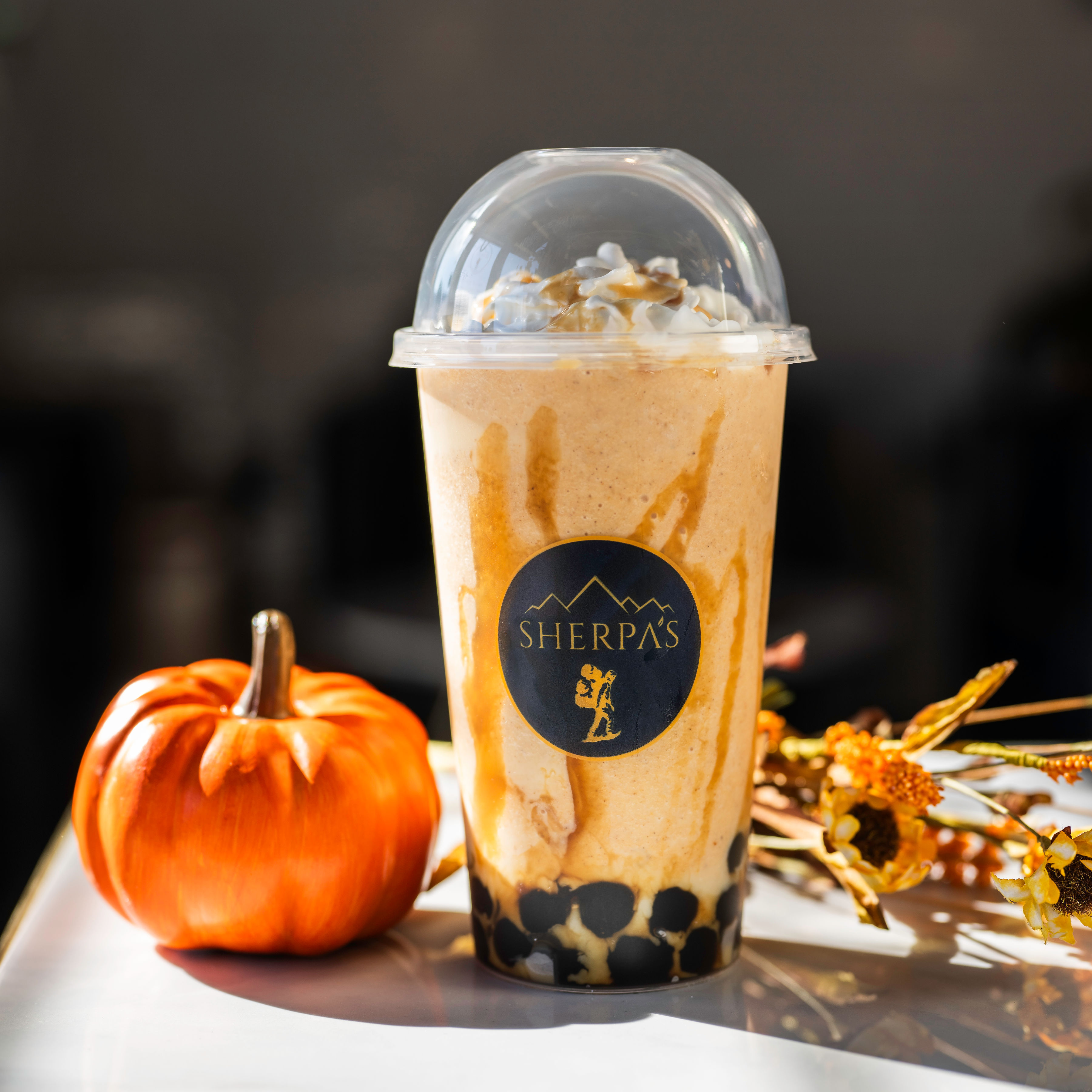 Boba drink with caramel drizzle and whipped cream topping at Café Sherpa's, Brookfield WI. Made fresh in-house daily with multicultural flavors guided by French technique.