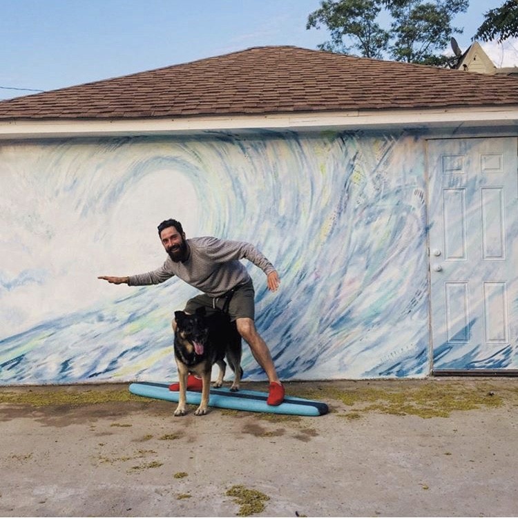 Alex Bentsen and dog on a surfboard