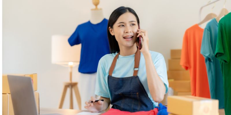 A business owner on their phone. 