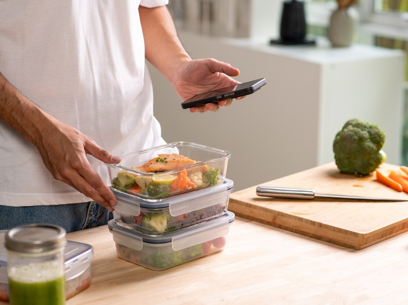man checking the calories of his meal prep on his phone, showing what works better than an Epsom salt detox bath weight loss
