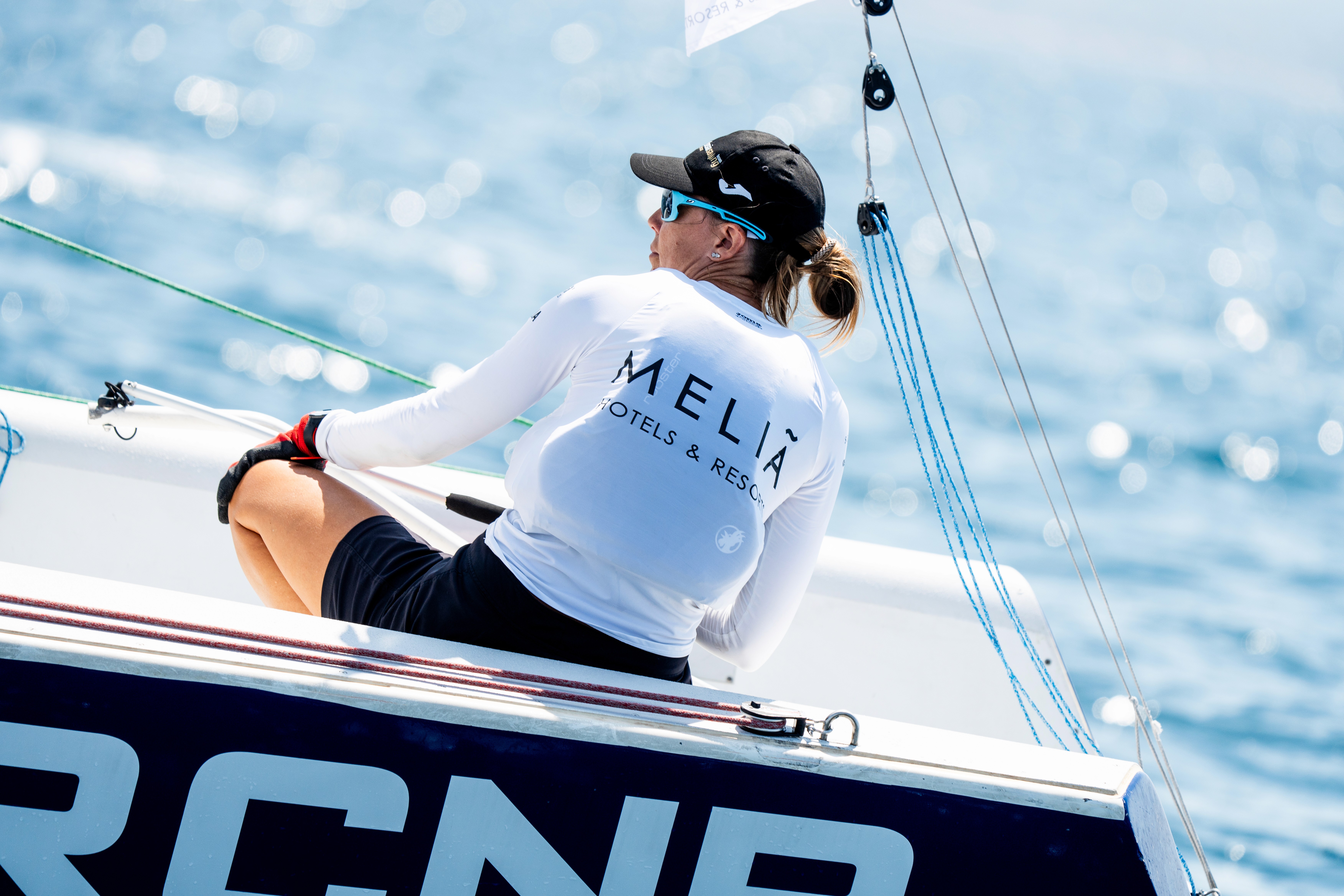 A woman with a head made of mirrors, reflecting light and creating a kaleidoscopic effect around her.