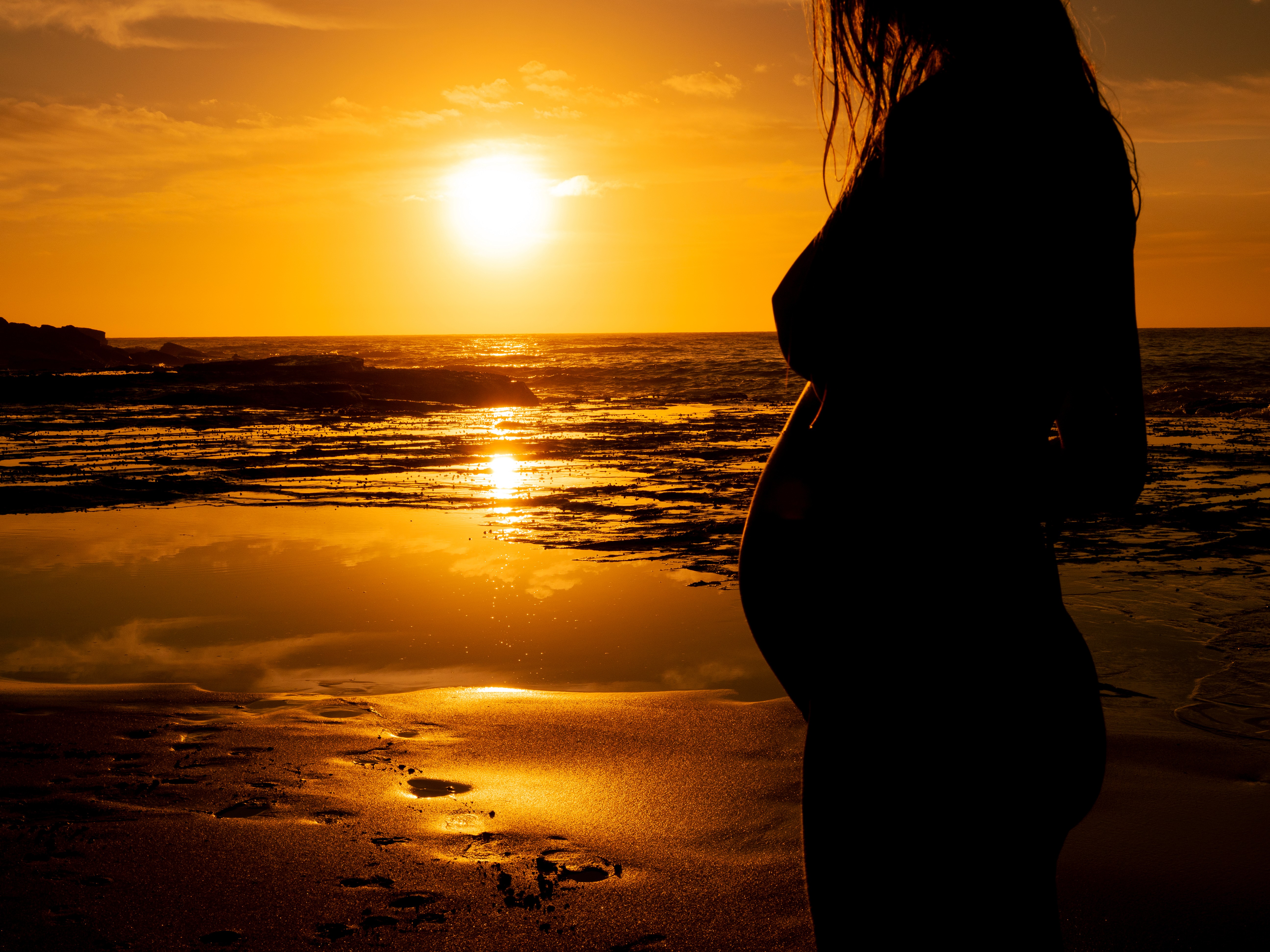 Elf woman in white dress raising hands by the river