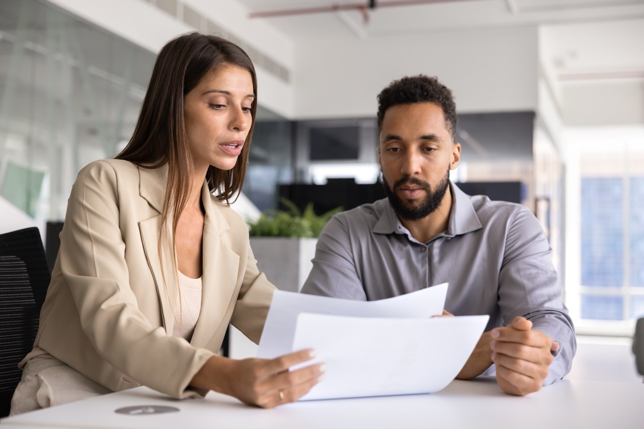 Woman and man looking at business papers