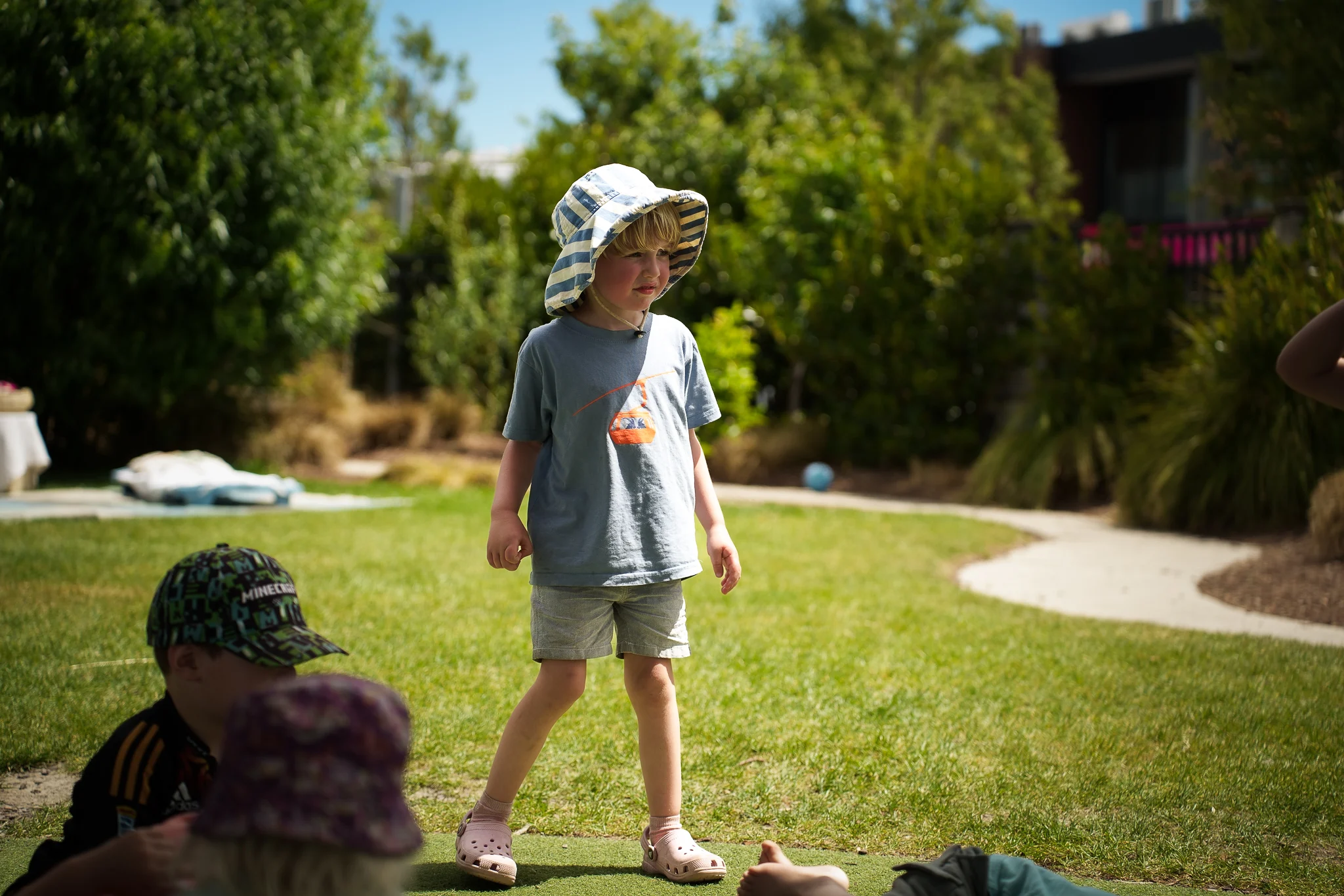A young child exploring the outdoor environment during playtime.