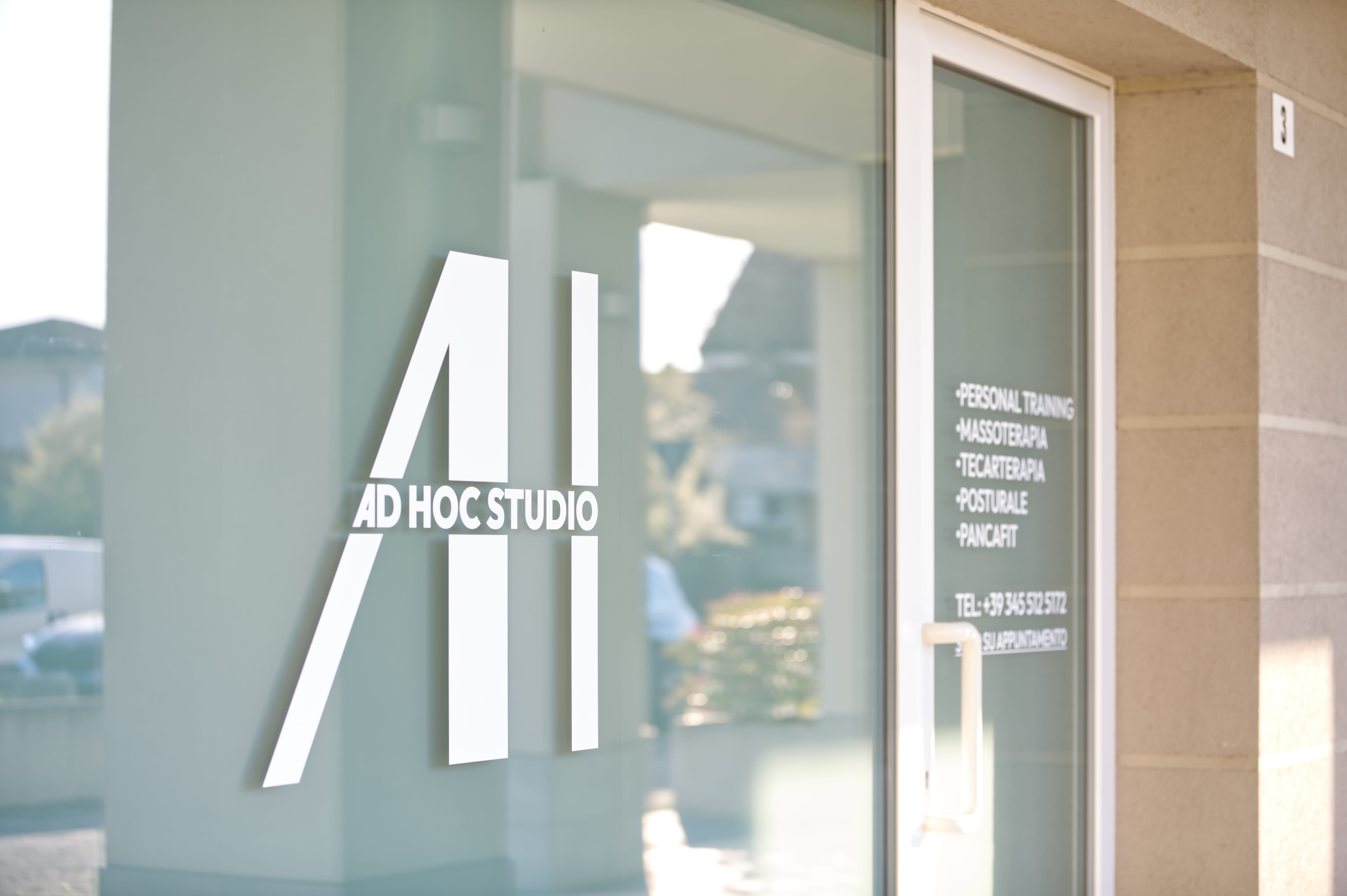 Two people sit across a table in a stylish room with red velvet walls and a large red pendant light. The mood is intimate and modern.