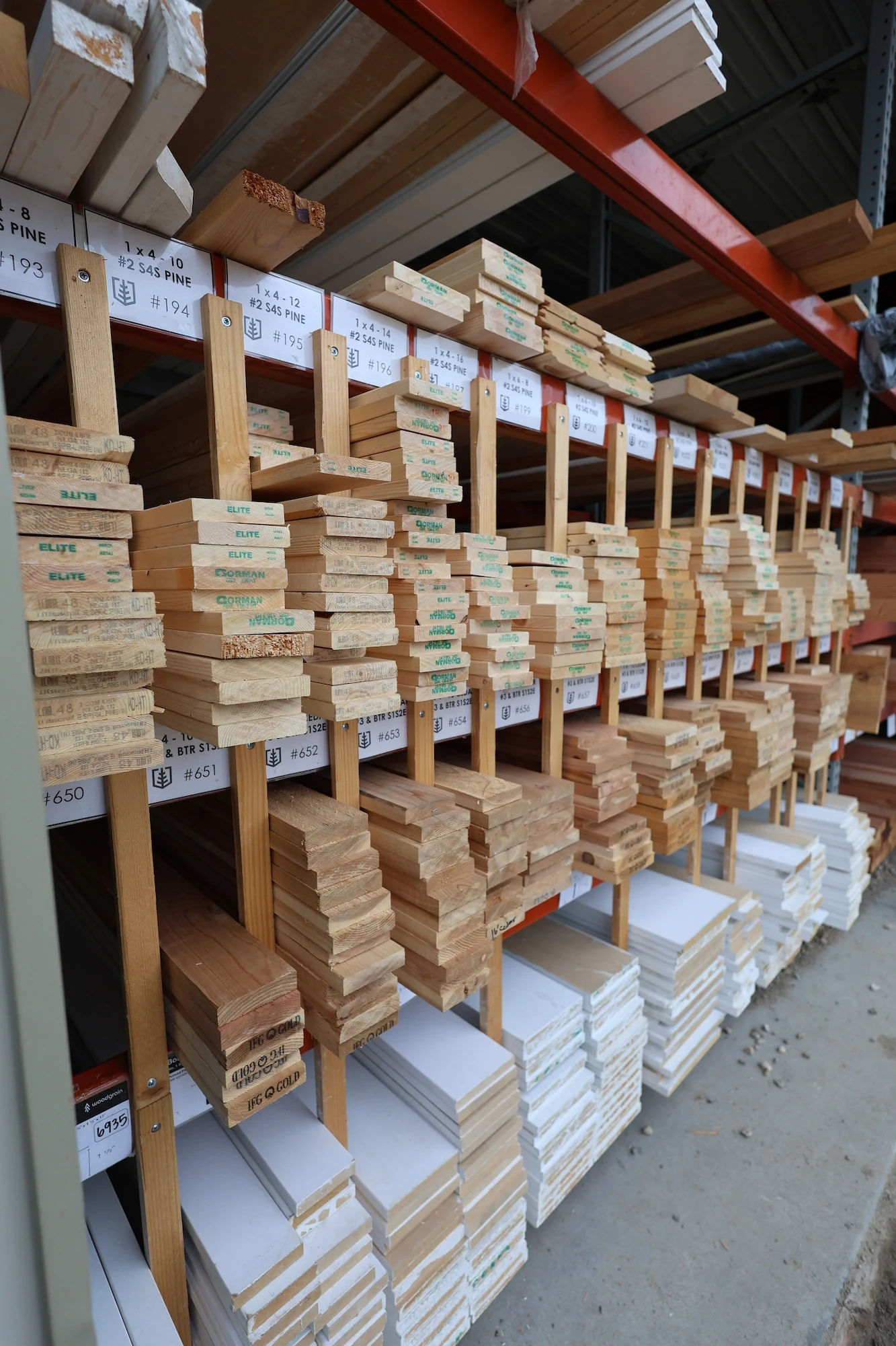 Stacked dimensional lumber stored beneath the Capital Lumber yard canopy
