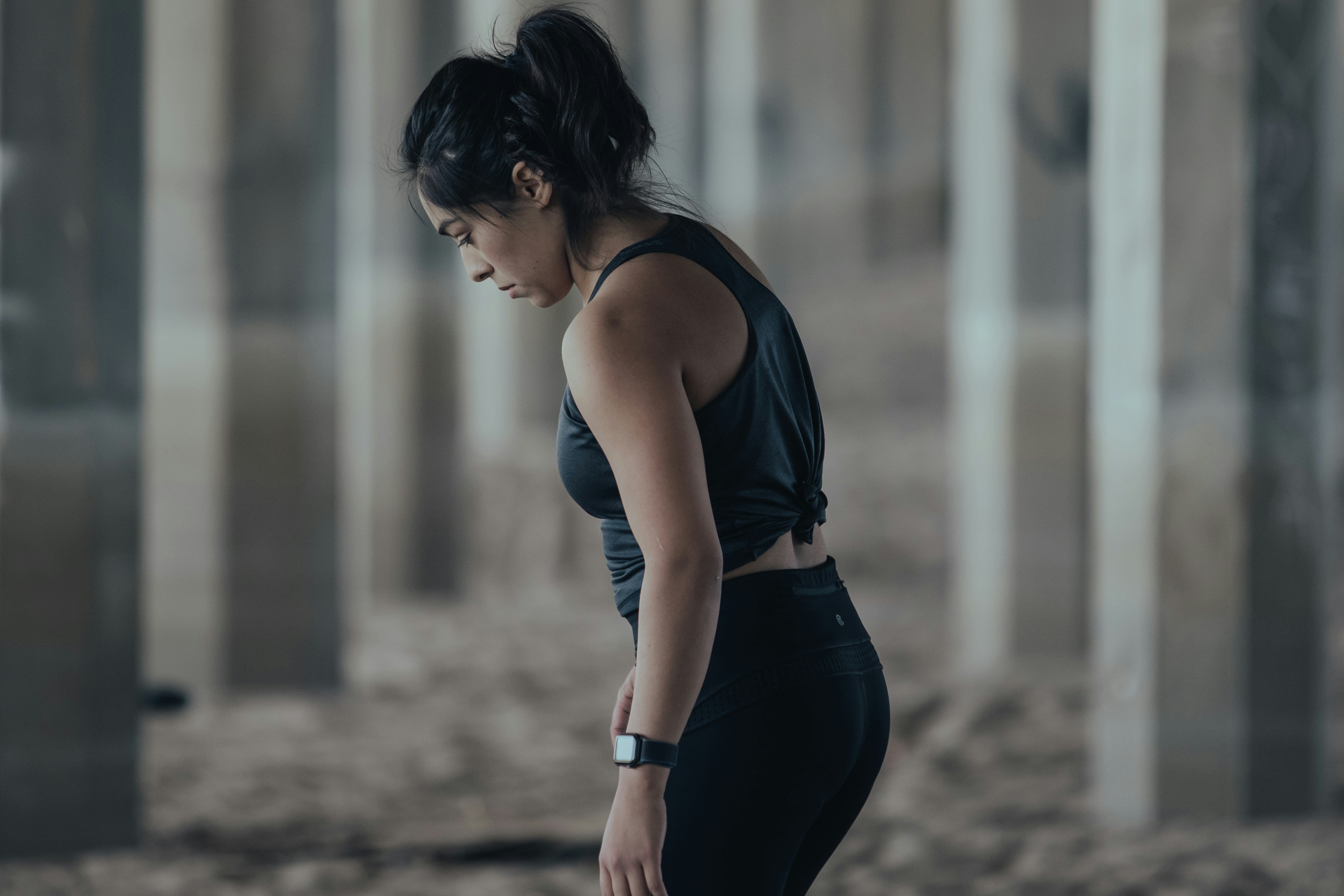 woman in blue tank top and black leggings