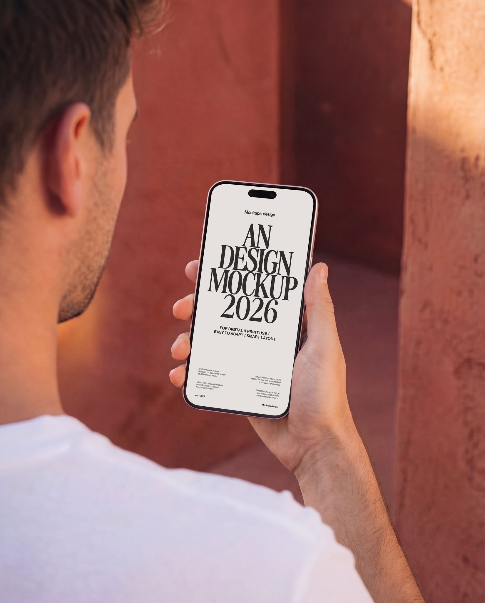 Man holding iPhone 16 mockup, realistic outdoor scene