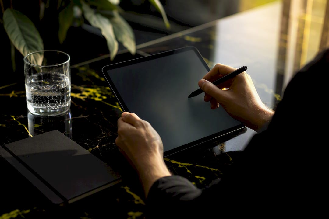 Hands maintaining negative keywords on tablet