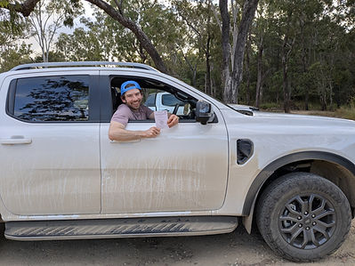 Jamie Patrick in a truck showing an International Driving Permit