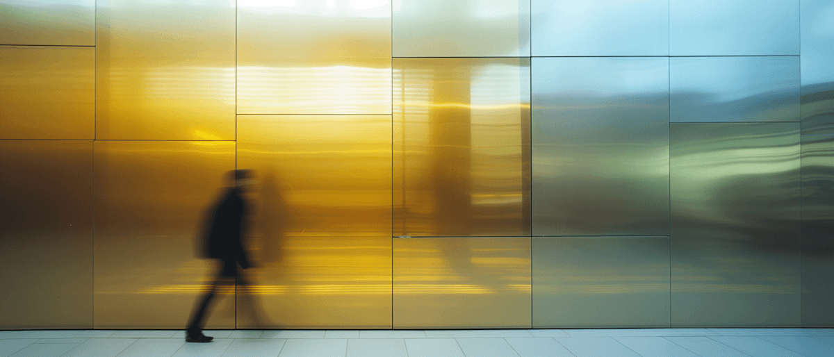 woman in blue tank top standing beside white wall
