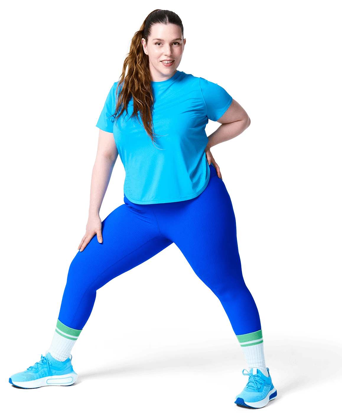 A person in sportswear is lifting one knee while standing on one leg, showcasing a workout or stretching activity.