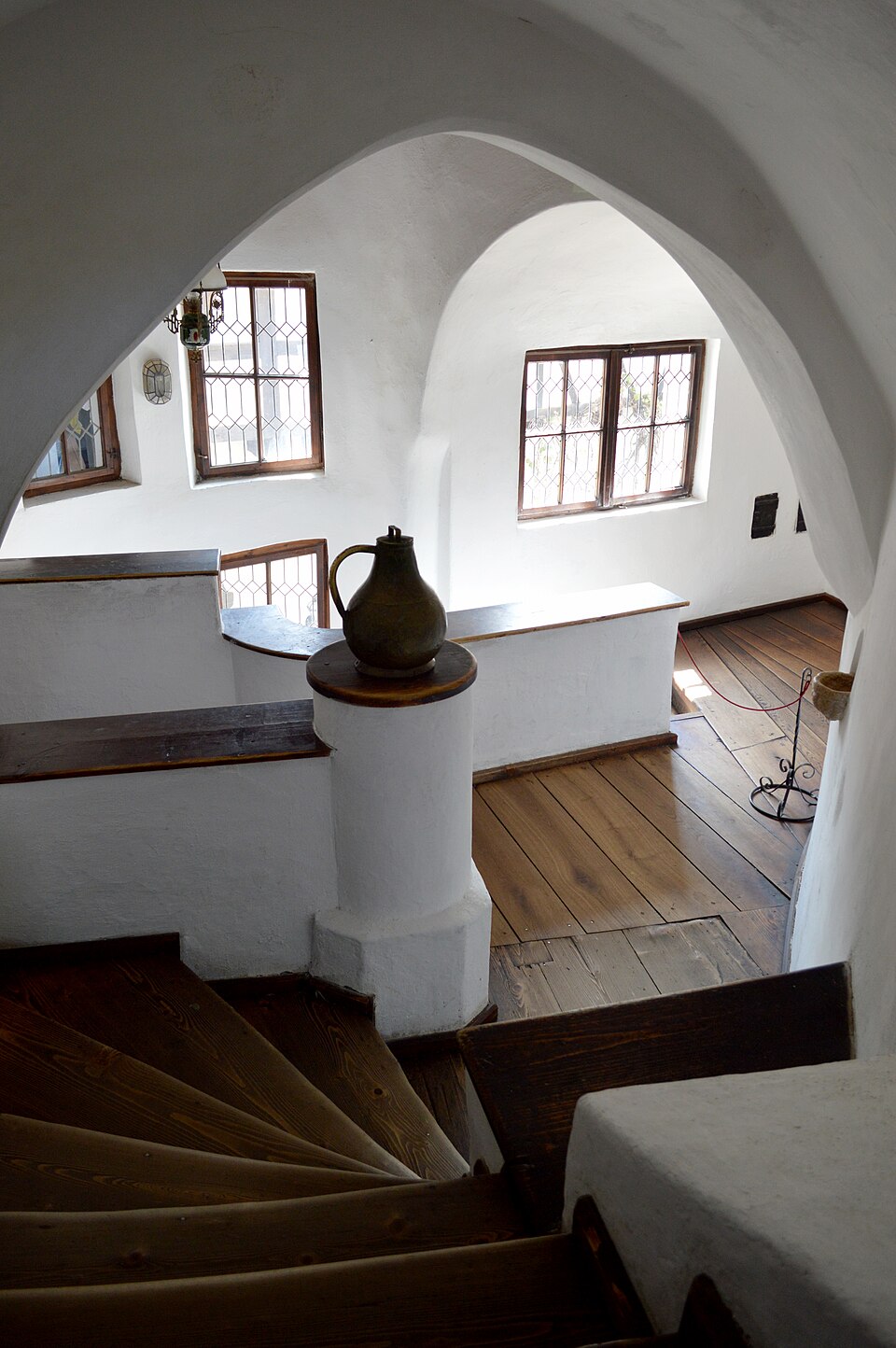 a tree with pink flowers in front of a store