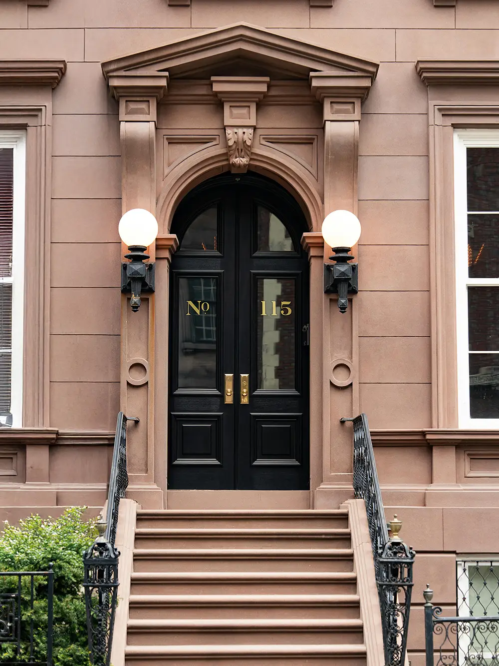 The stoop of a brown stone building in New York City, the kind that would represented by a New York City buyers agent