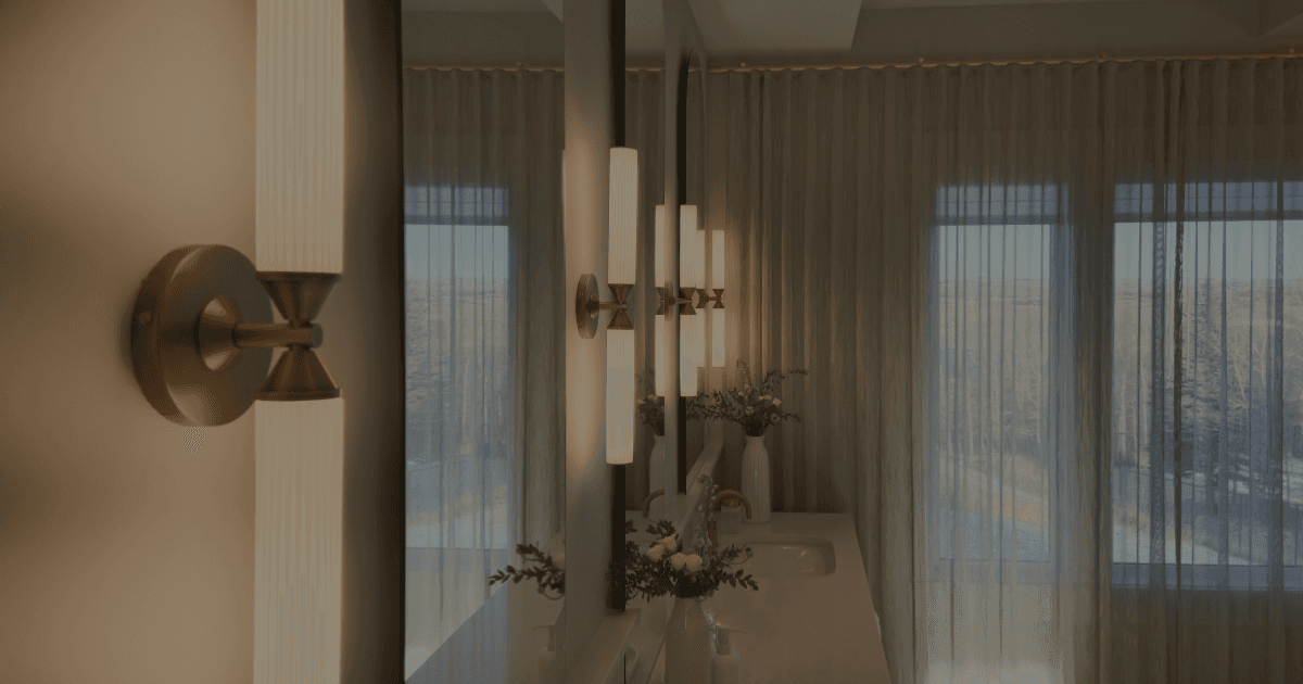 A luxury bathroom vanity with vertical linear sconces illuminating the arched mirrors in a soft light.