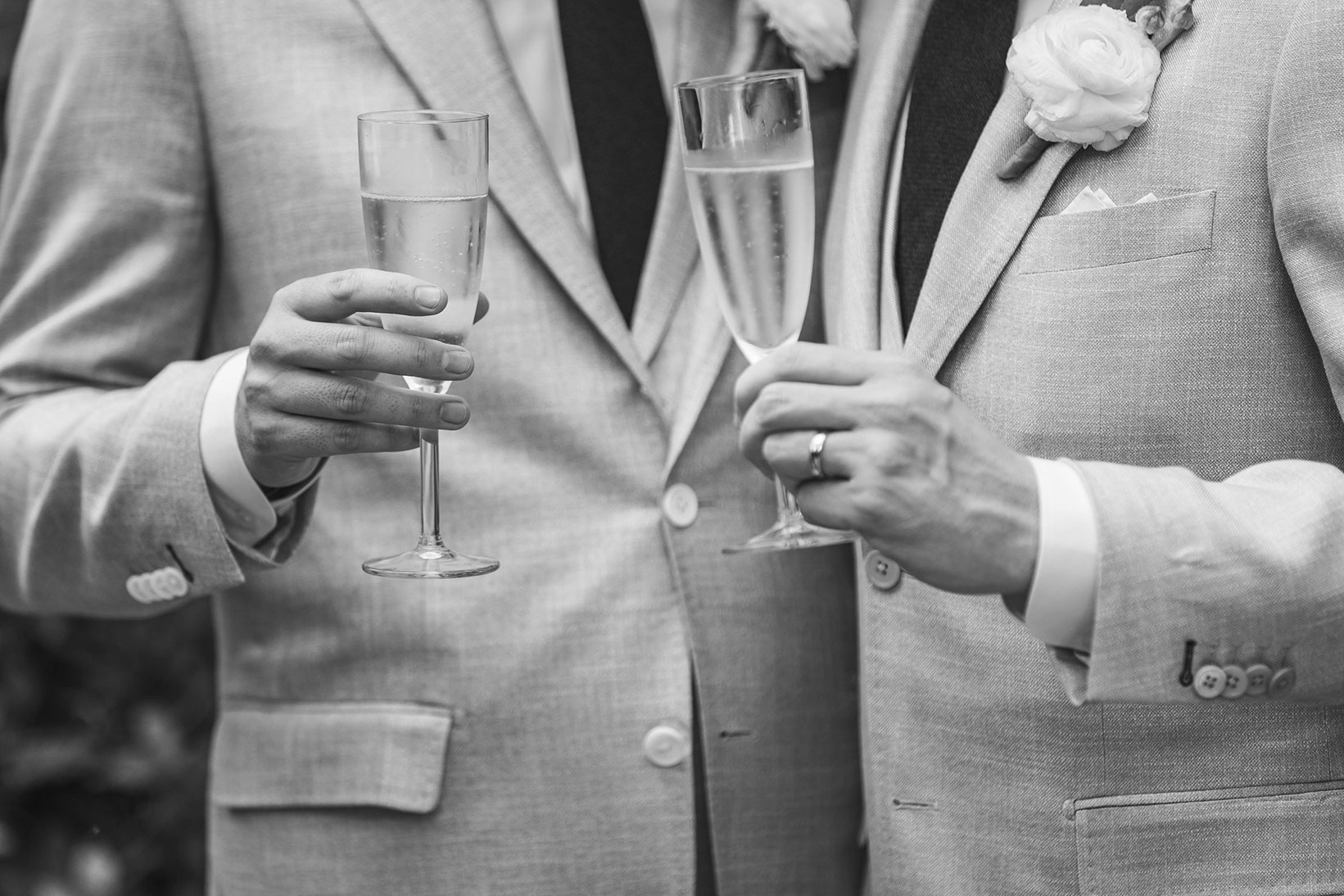 Black-and-white toast with champagne flutes and white boutonnieres.