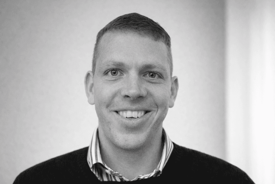 Portrait of a smiling man in black and white. Close-up with a friendly facial expression.