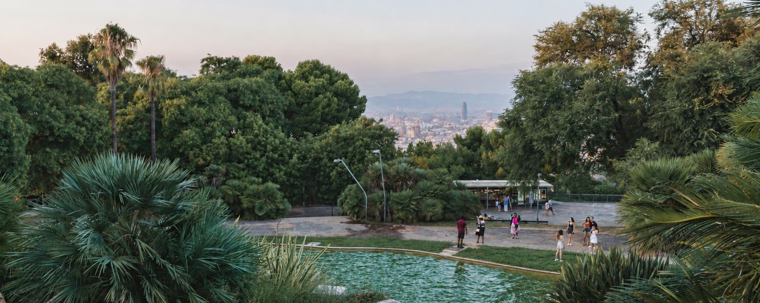 Fountain pools and palms in a Montjuïc garden with the city behind