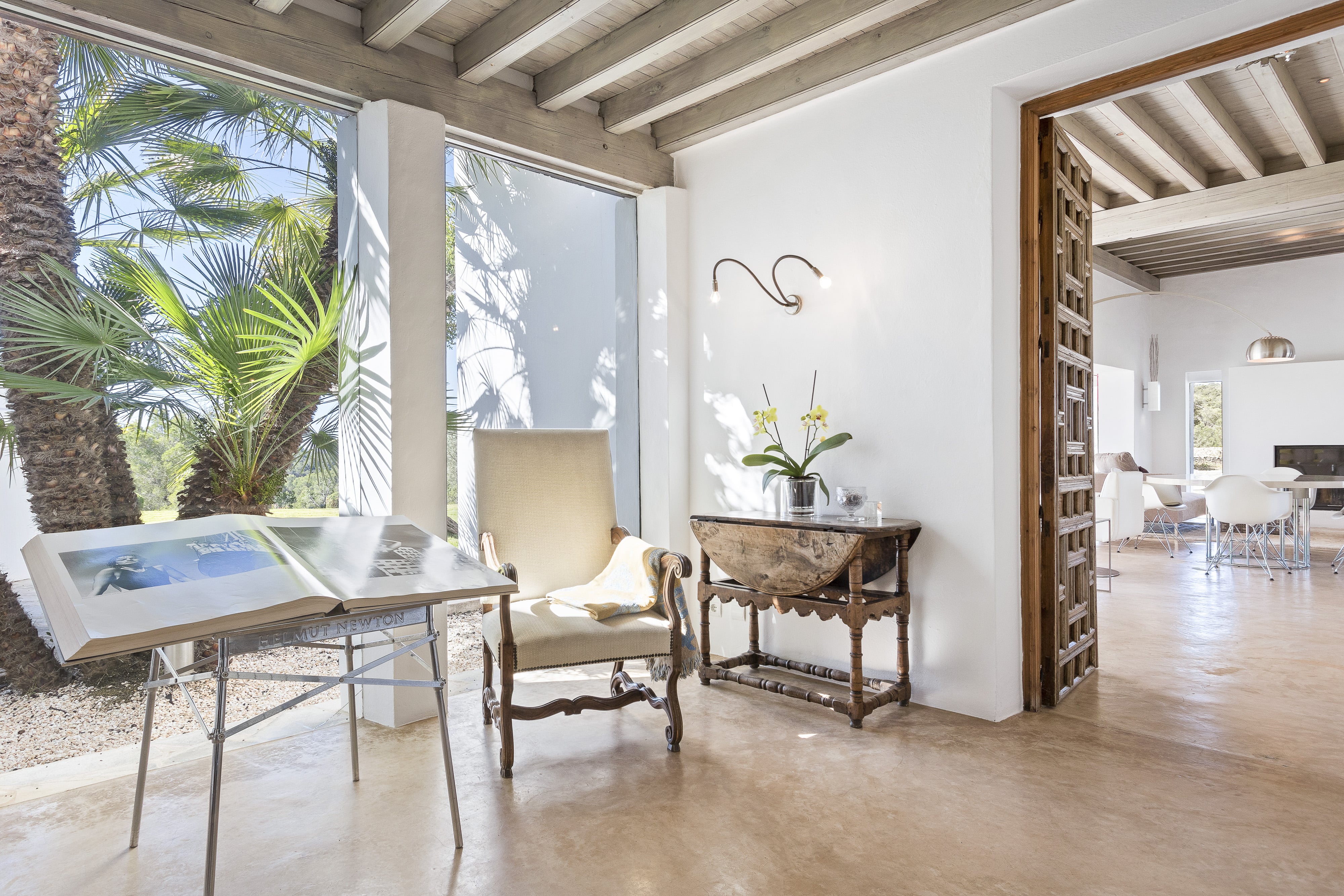 Inviting House Entrance with Cozy Lounge Chair, Stylish Desk, and Impressive Book 