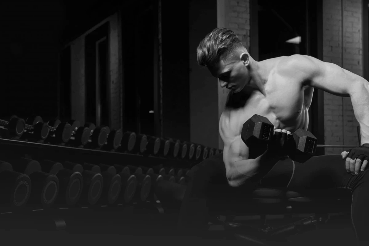 Man lifting dumbbells at the gym