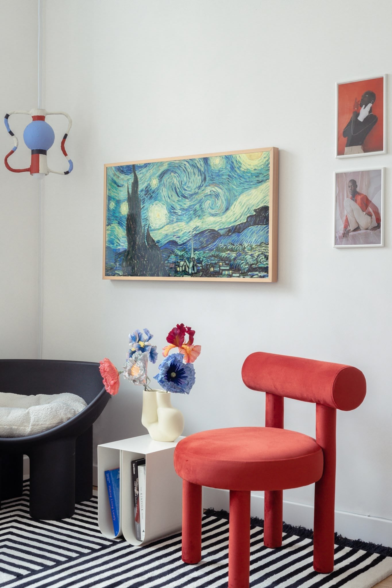 London new build interior design with characterful contemporary furniture, geometric rug, and quirky custom light fixture.