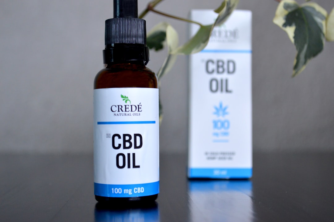 a bottle of cbd oil next to a box of cbd oil