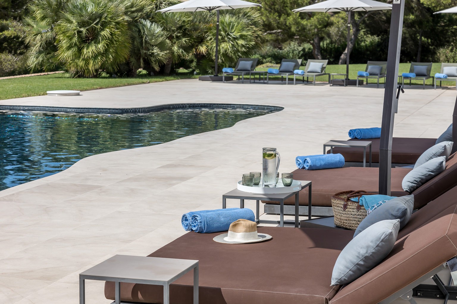Daytime drinks setup by the pool at the exclusive luxury villa in Ibiza—privacy-focused VIP estate property holiday retreat for weddings and events.