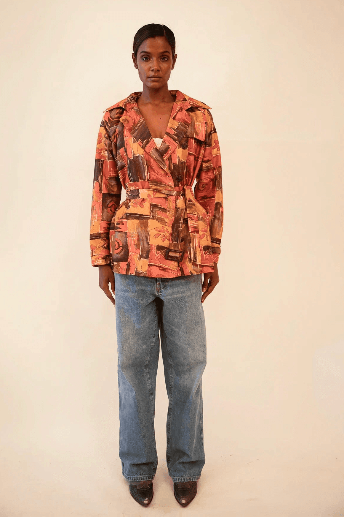 Cropped trench coat crafted from upcycled abstract print silk, featuring a relaxed fit and lightweight structure.