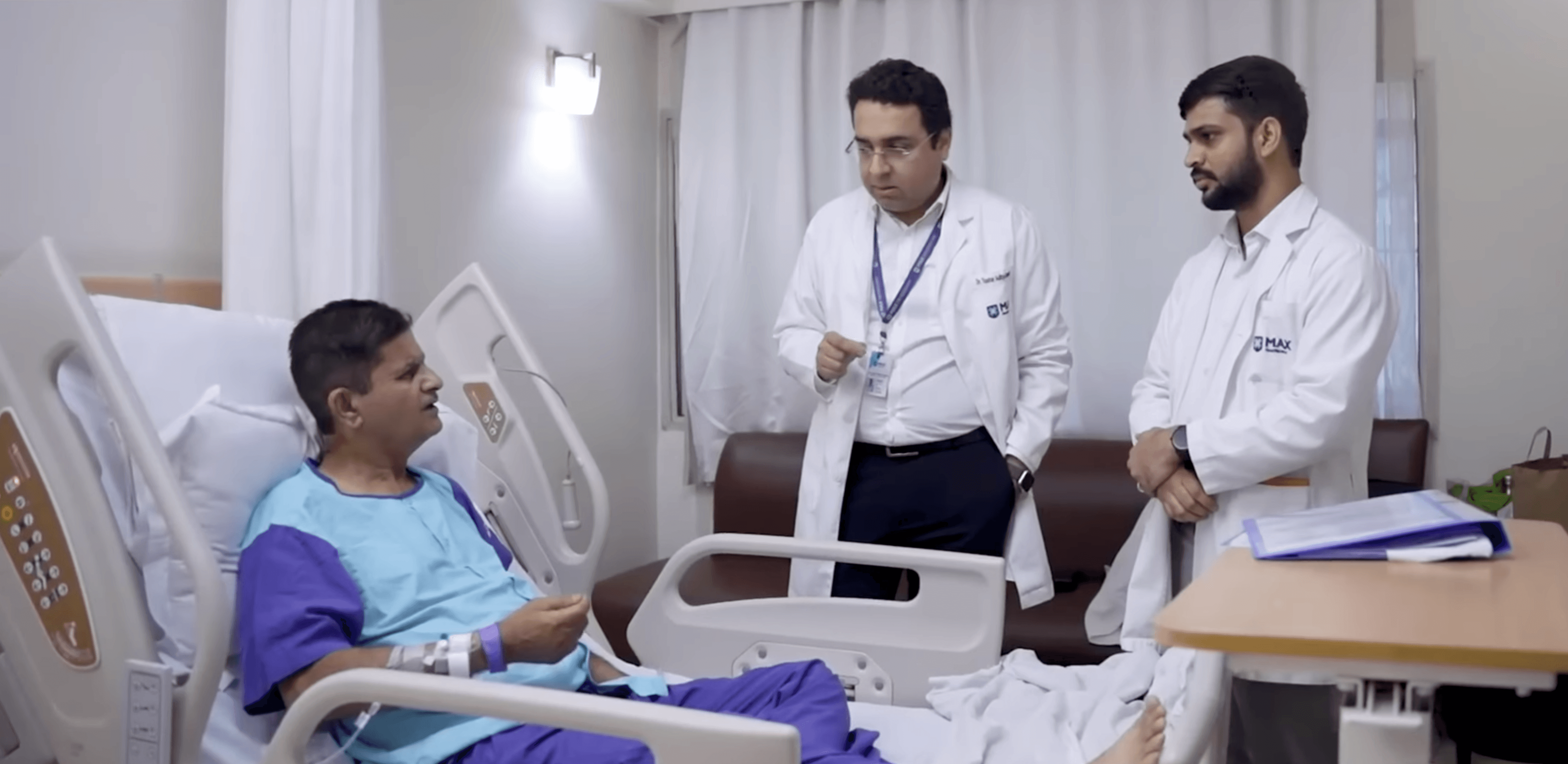Dr. Tushar and Manish standing by a patient's bedside, providing personalized guidance and checking on their recovery.