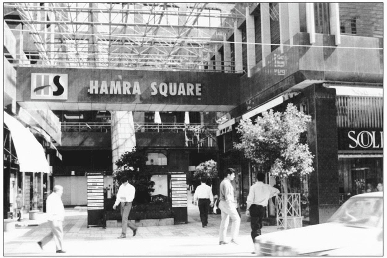 People are walking through a large art gallery.