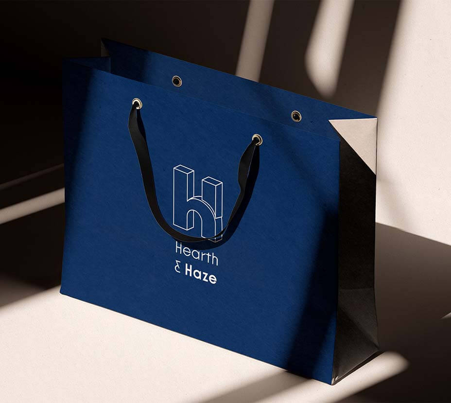 Hearth & Haze project graphic showing a blue homewear bag featuring the flexible logo monogram design