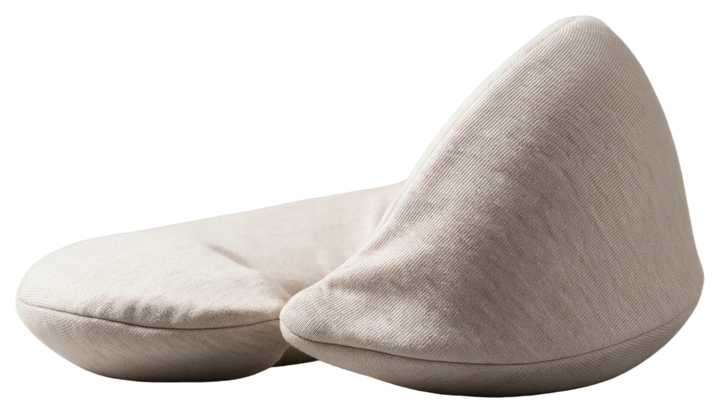 Cervia pillow in Oat seen from the side, tall at the front and flat at the back