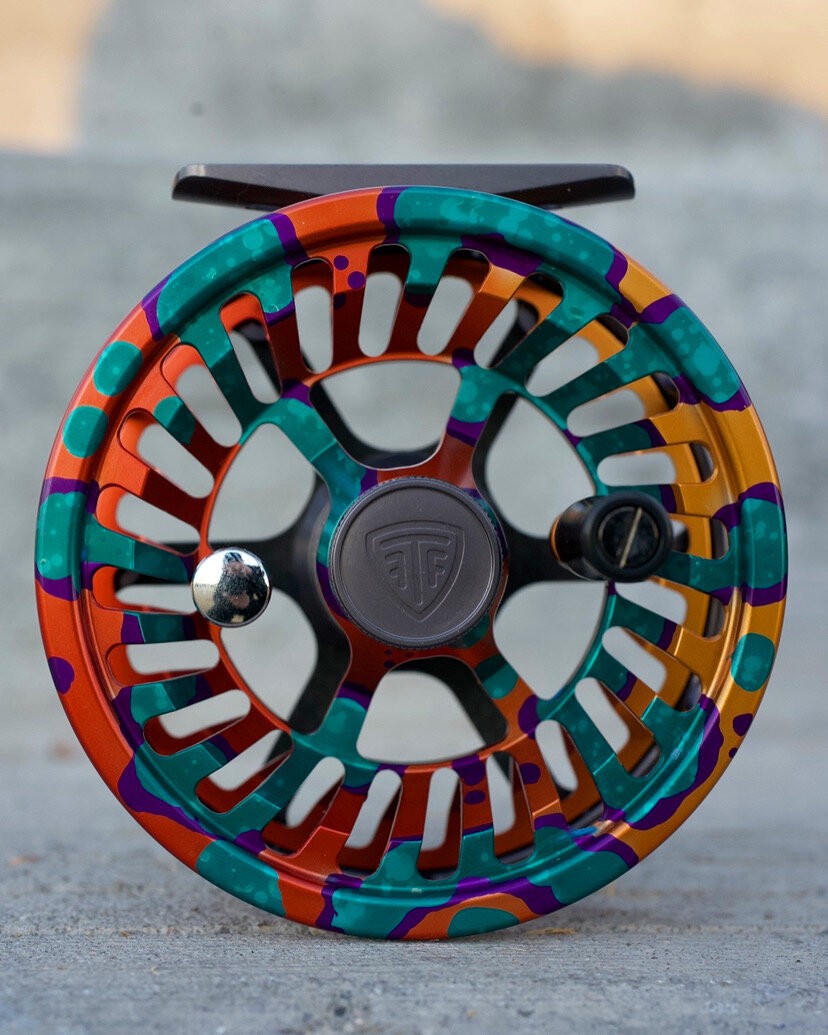 custom color fly fishing reel orange teal and purple