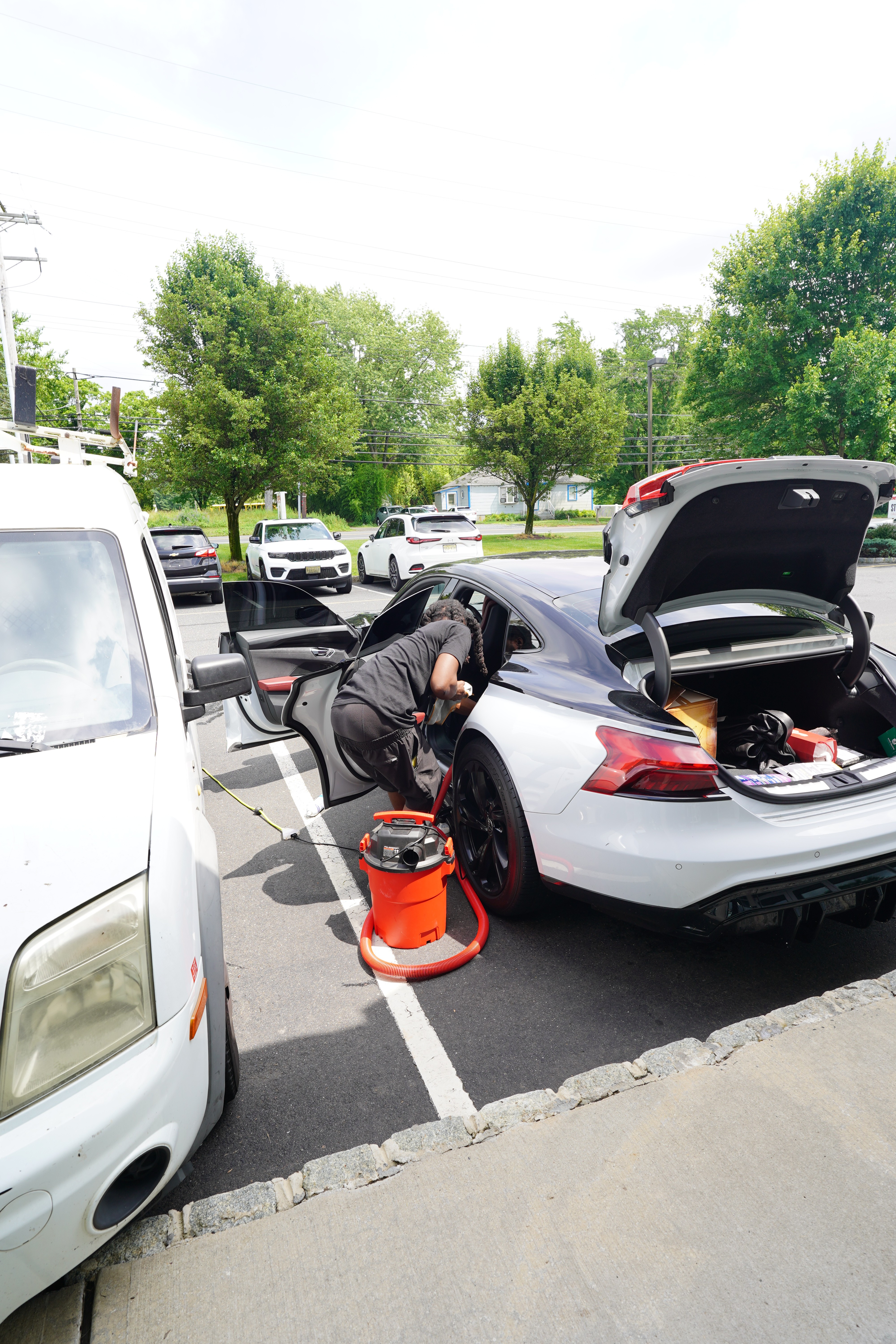 Fleet of delivery vans being detailed at business location NYC