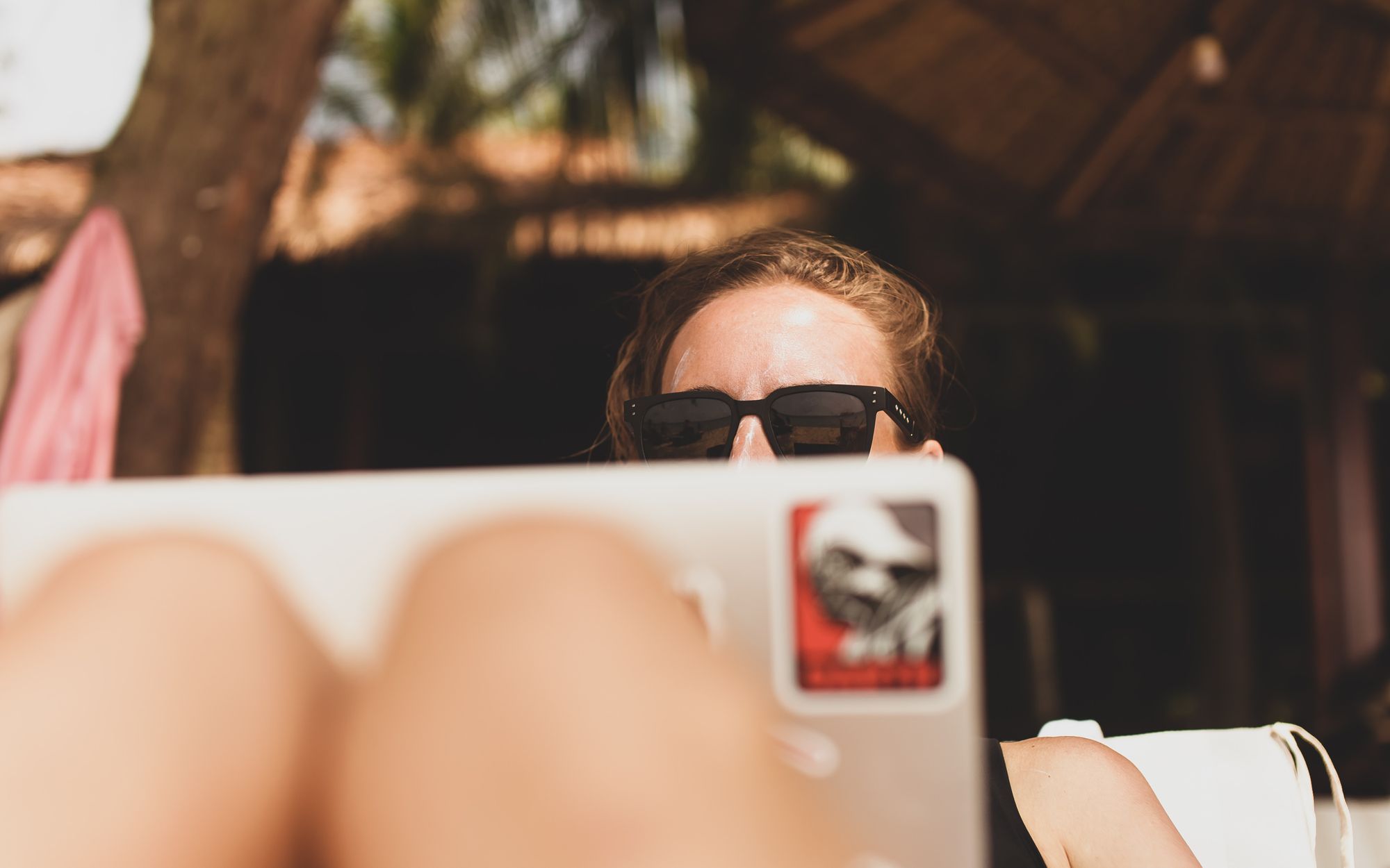 Woman on laptop embracing remote work to travel the world