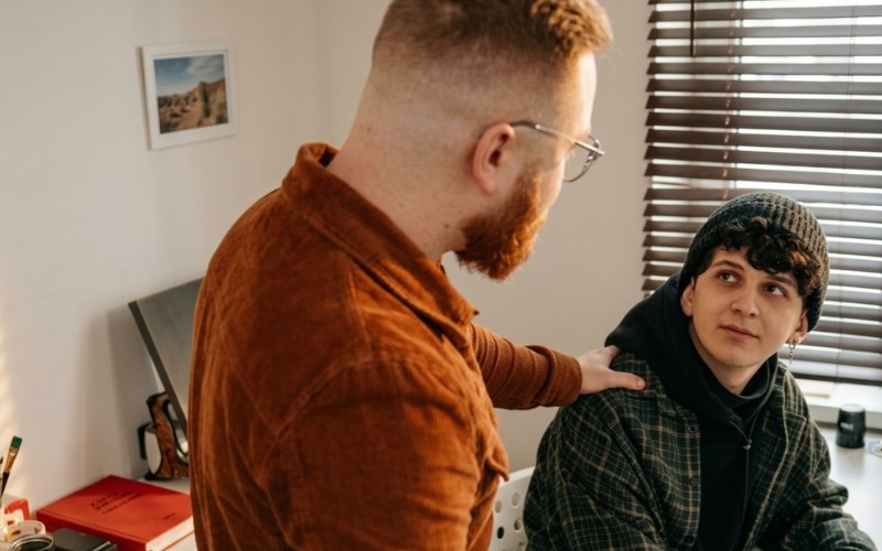 Workplace interaction showing sympathy and reassurance from a manager