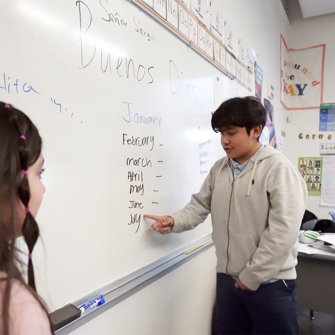 Middle school students engaging in Spanish speaking and listening activities”