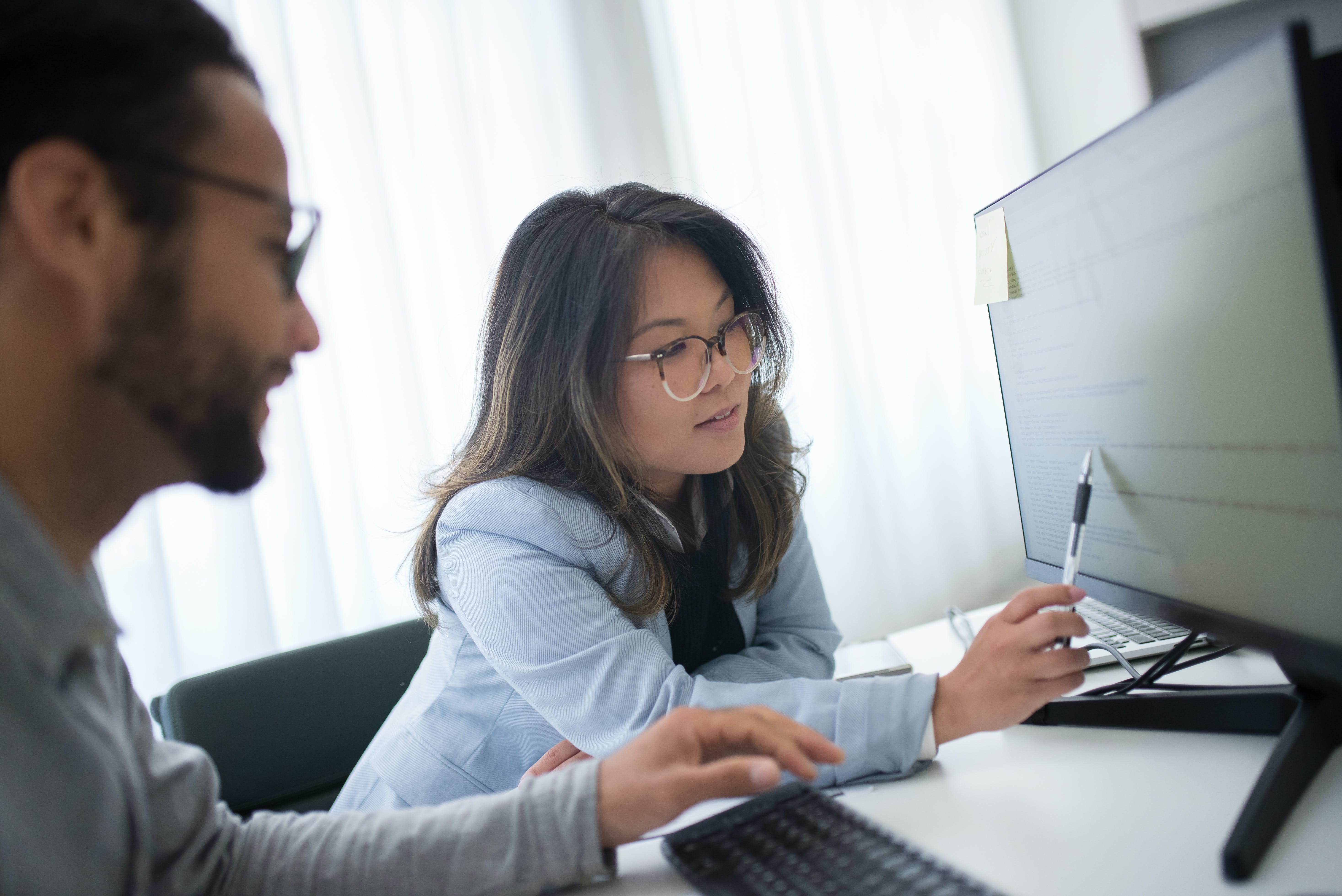 Woman pointing on the computer monitor displaying email spam