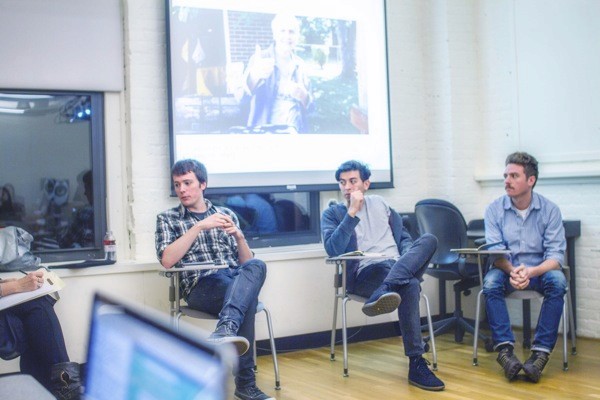 A photo of a group of people sitting in a classroom and listening to a lecture.