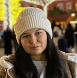 A smiling happy customer with curly hair on a blue background
