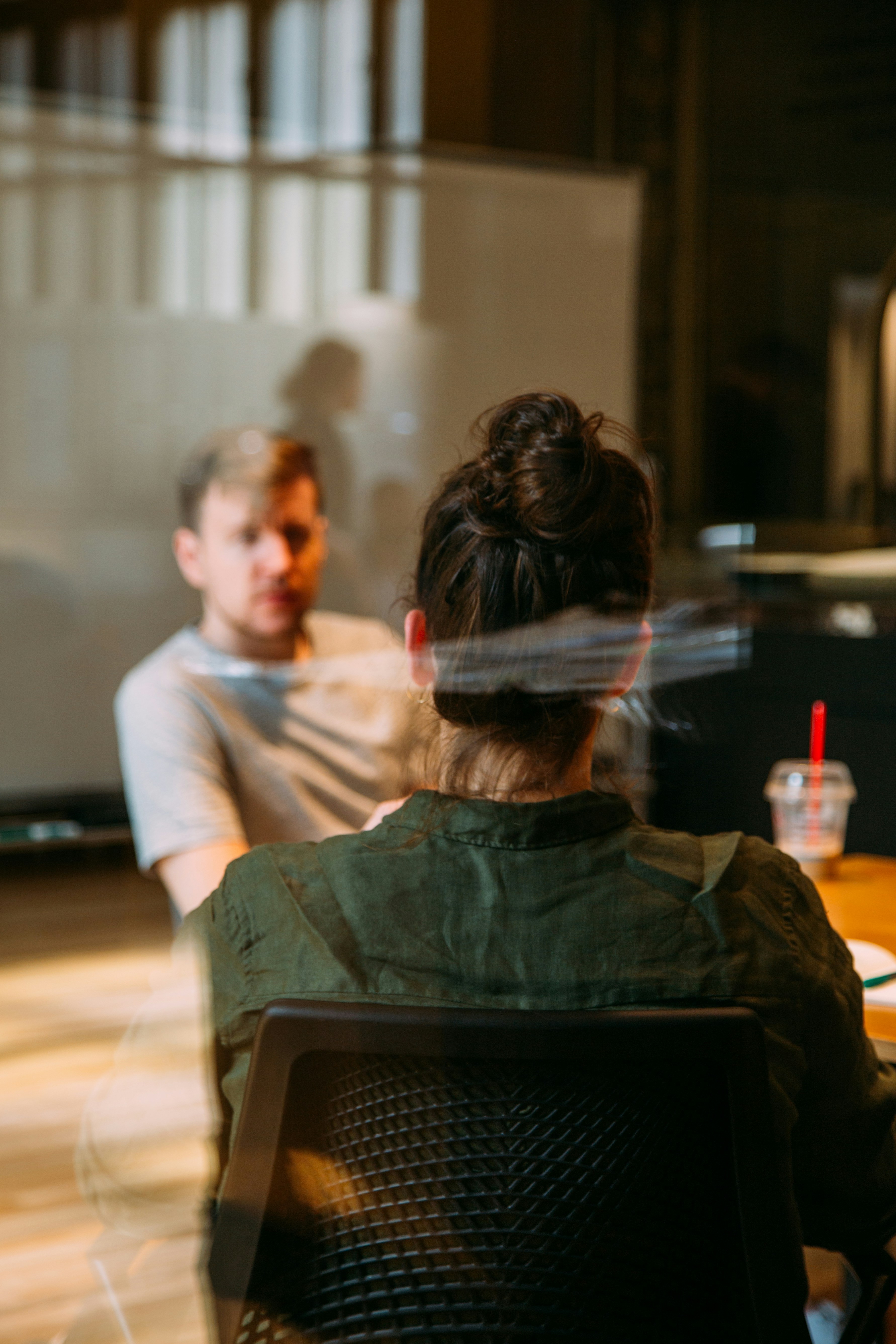 In a meeting in a glass office