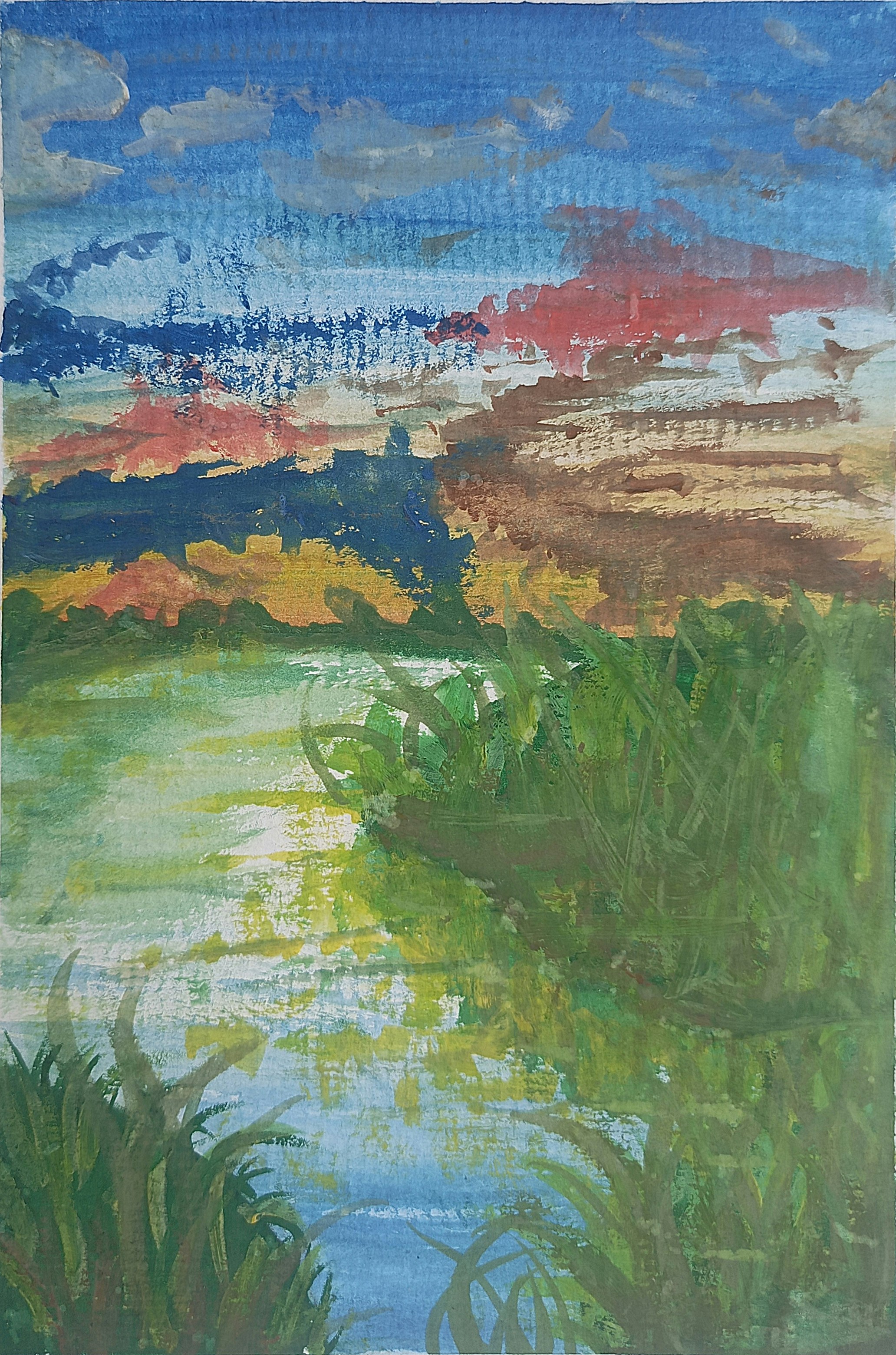 Sunset paints the clouds over a serene lake.