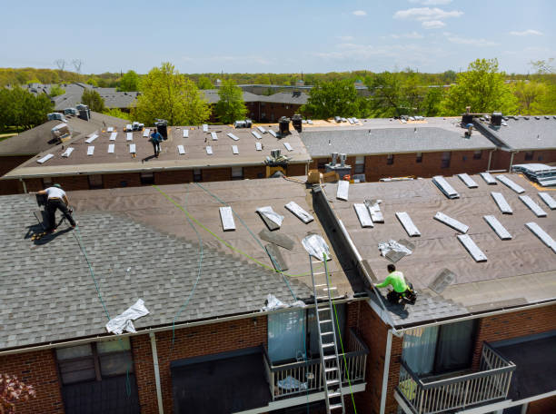 two men working on the roof of a house
