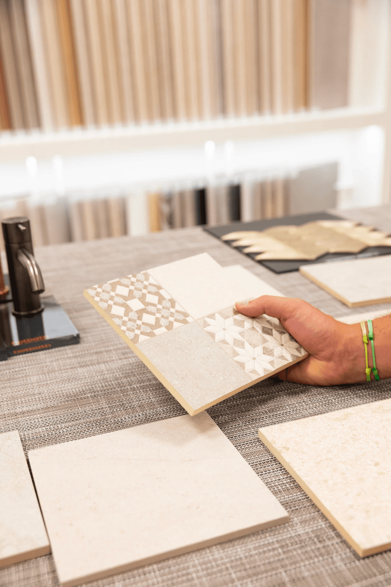 Modern interior space with a blue circular coffee table, flowers in a vase, and books neatly arranged.