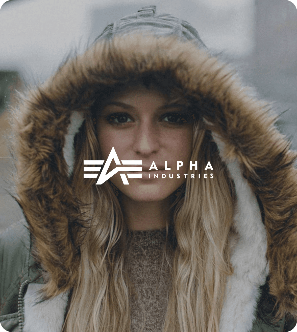 woman wearing an alpha industries jacket with a faux fur hood