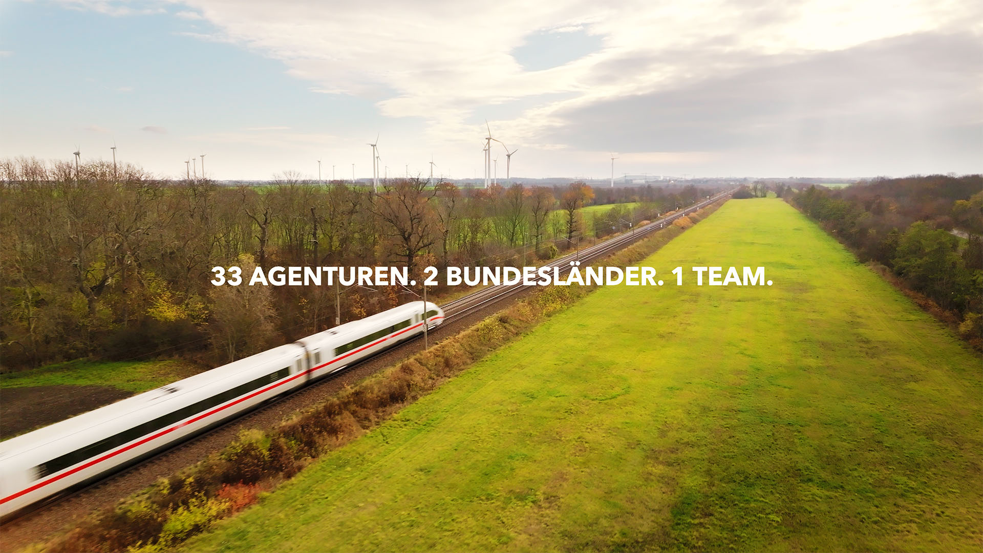 High-speed train captured by FPV drone, showcasing strategic filmproduction for an imagefilm campaign in lush countryside.