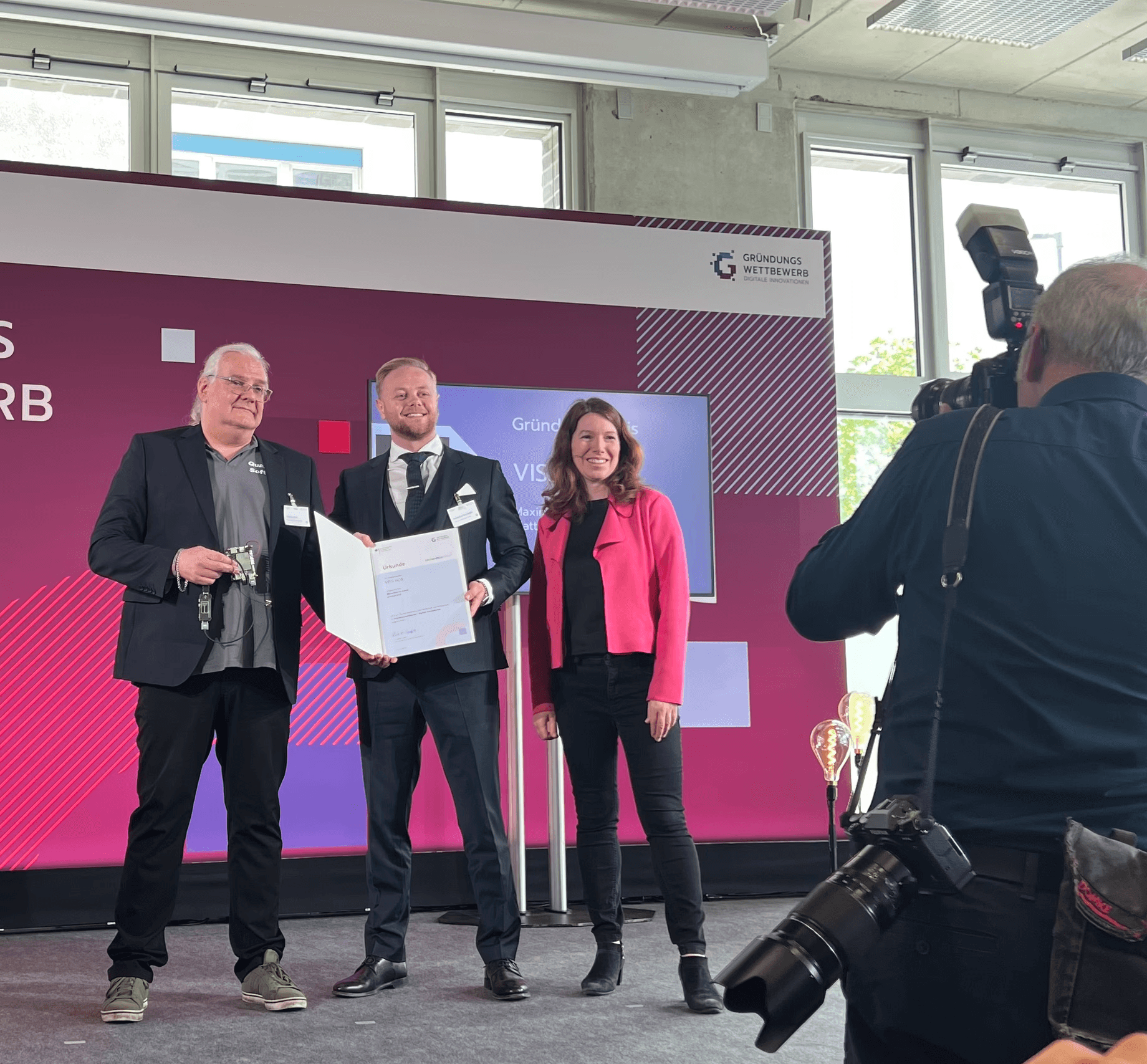 three people sitting in front of table laughing together