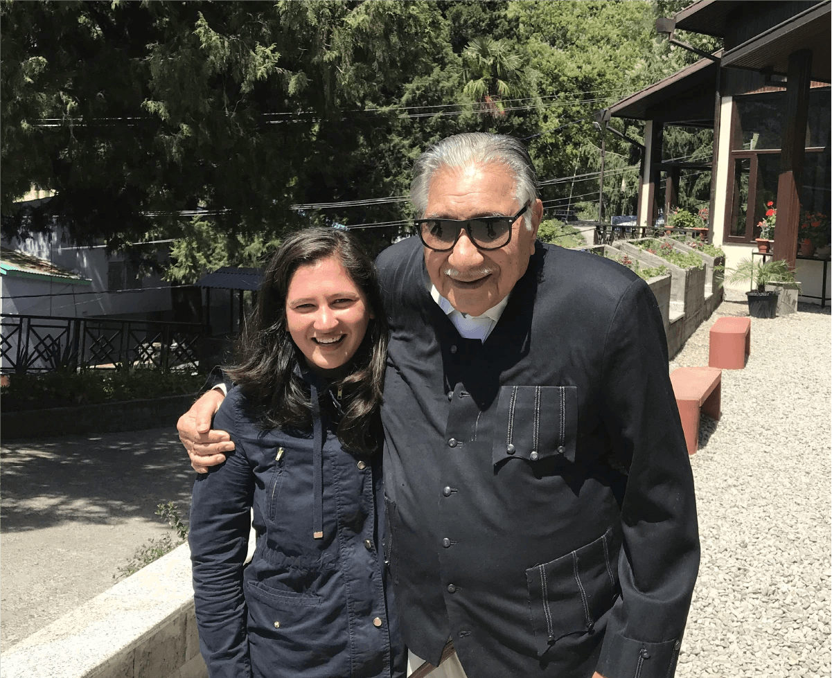 Shri Lalit Prasad Naithani, the family patriarch, smiling outdoors with a younger Priyanka K. Naithani.